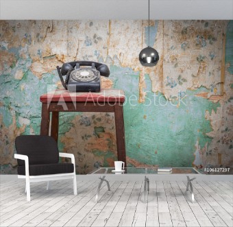 Picture of Old vintage phone on a chair stool in front of grunge wallpaper background